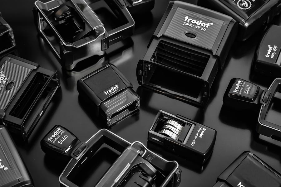 Group of Trodat Self Inking Stamps with a black background, showcasing a variety of designs for office and personal use.
