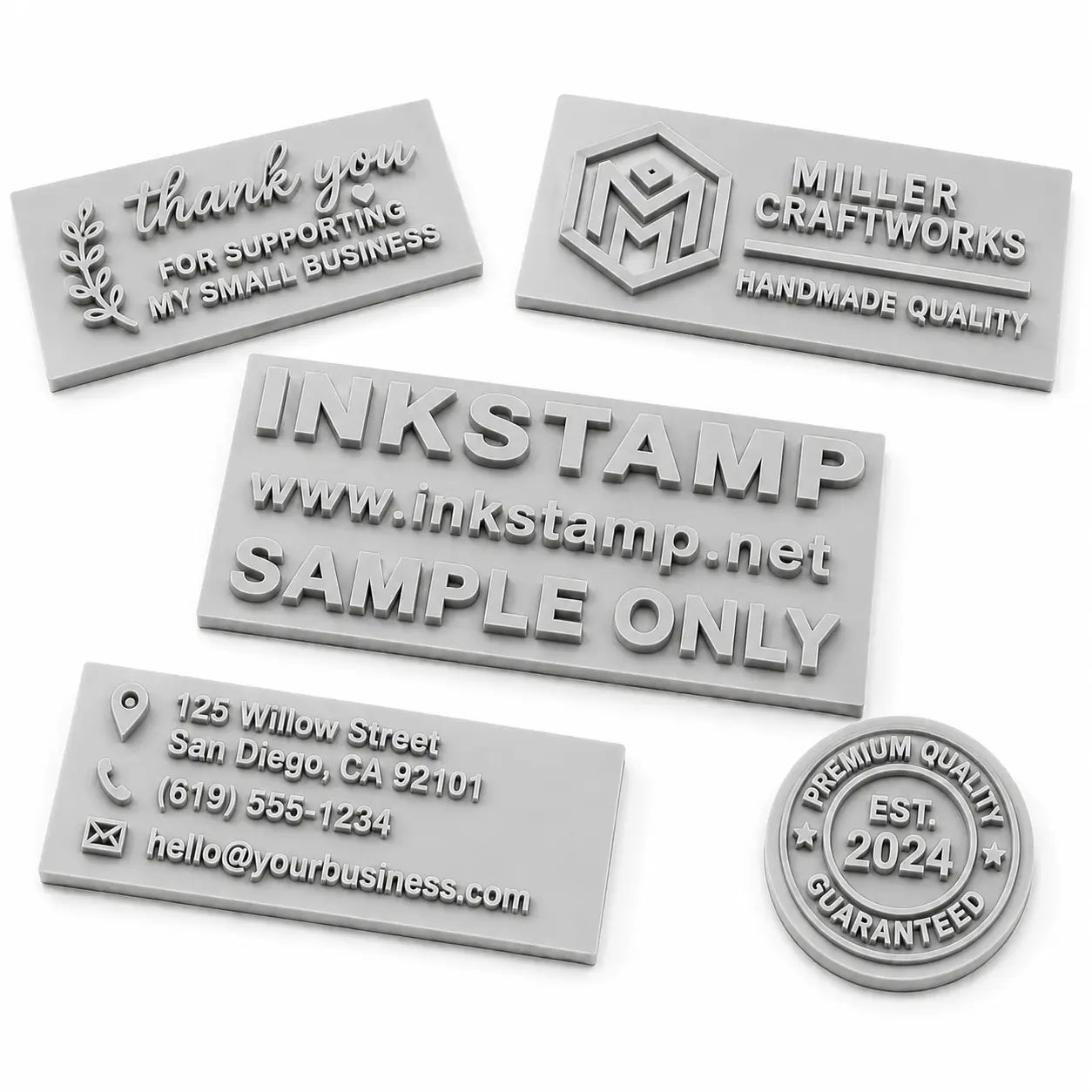 Collection of custom engraved rubber stamp dies with raised lettering and logo designs on a white background, showcasing different personalized rubber stamp engraving styles.
